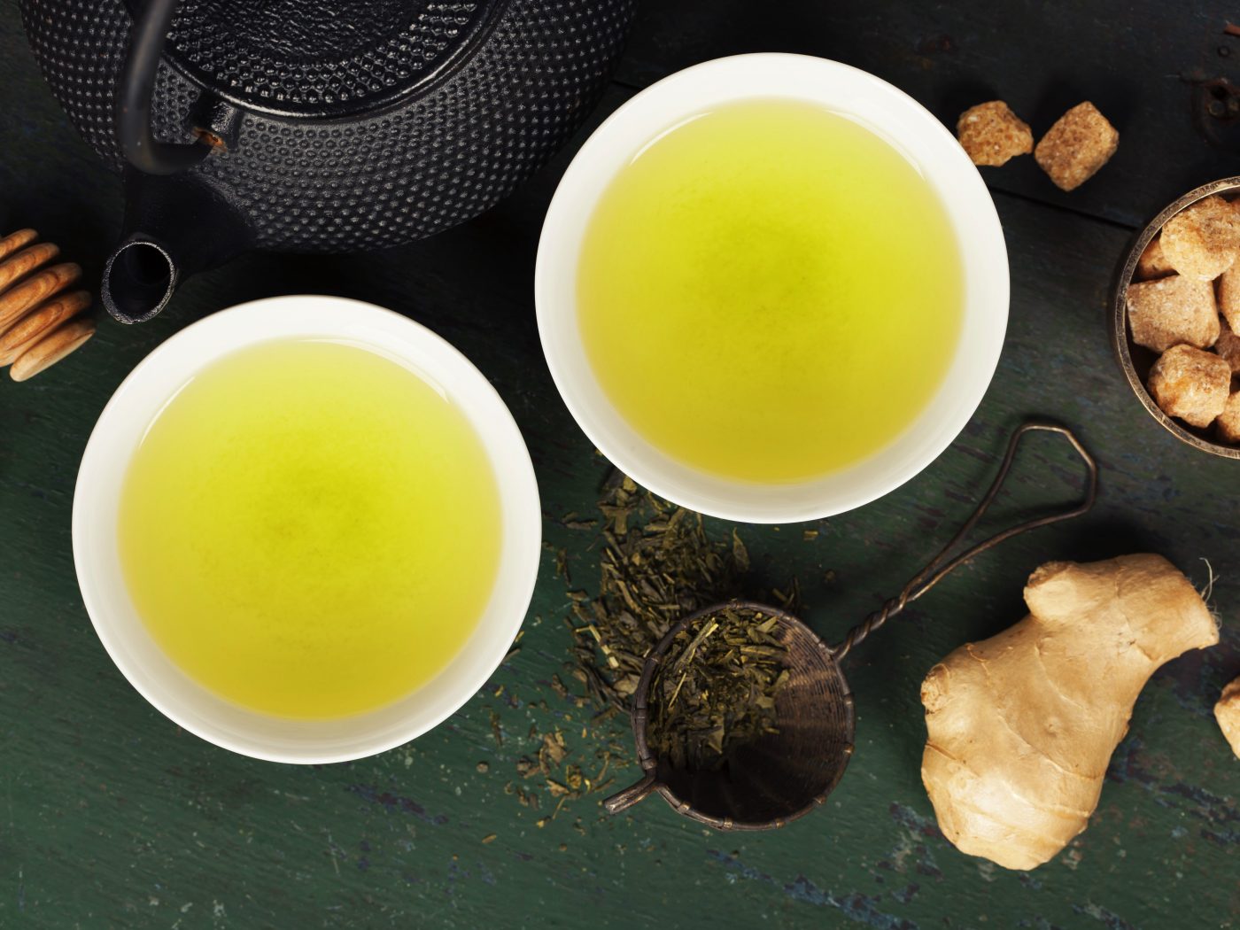 Cups with green tea on wooden background